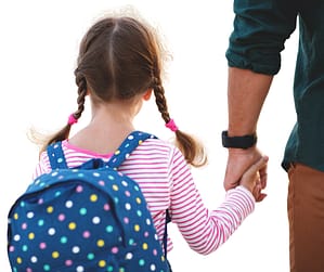 Petite fille avec cartable tenant la main de son parent pour la rentrée en maternelle